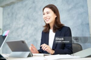 business woman doing desk work with a smile at office